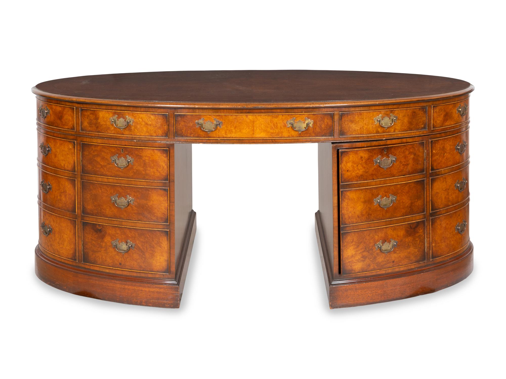 A George III Style Burl Walnut and Mahogany Oval Pedestal Desk