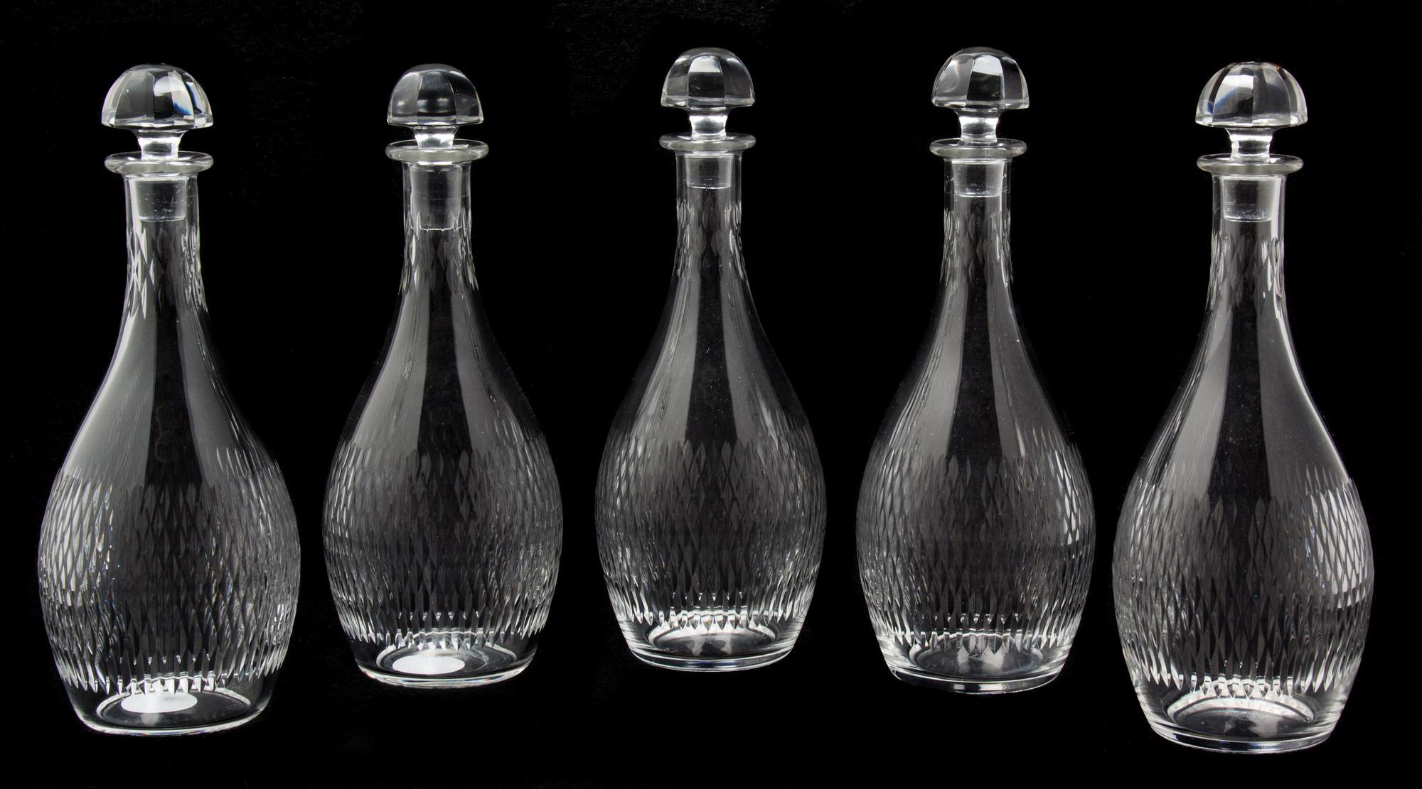 A Set of Five Baccarat Etched Glass Decanters Height 8 3/4 inches. — 20TH CENTURY