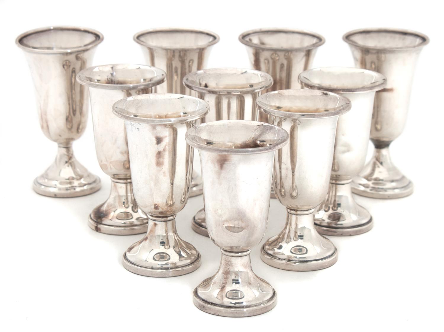 An Assembled Set of Ten Silver Cordials Height of tallest 3 1/4 inches.