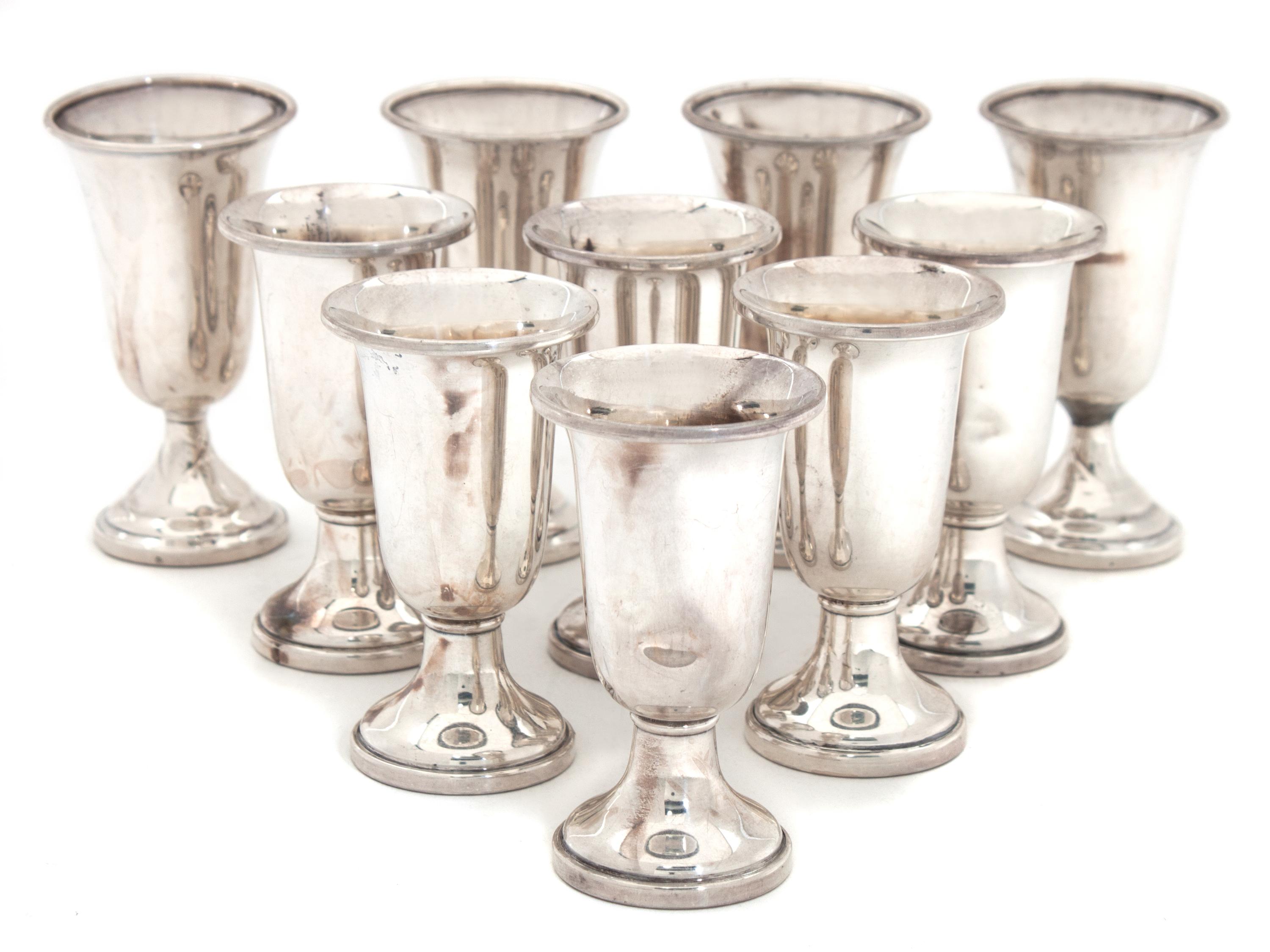 An Assembled Set of Ten Silver Cordials Height of tallest 3 1/4 inches.