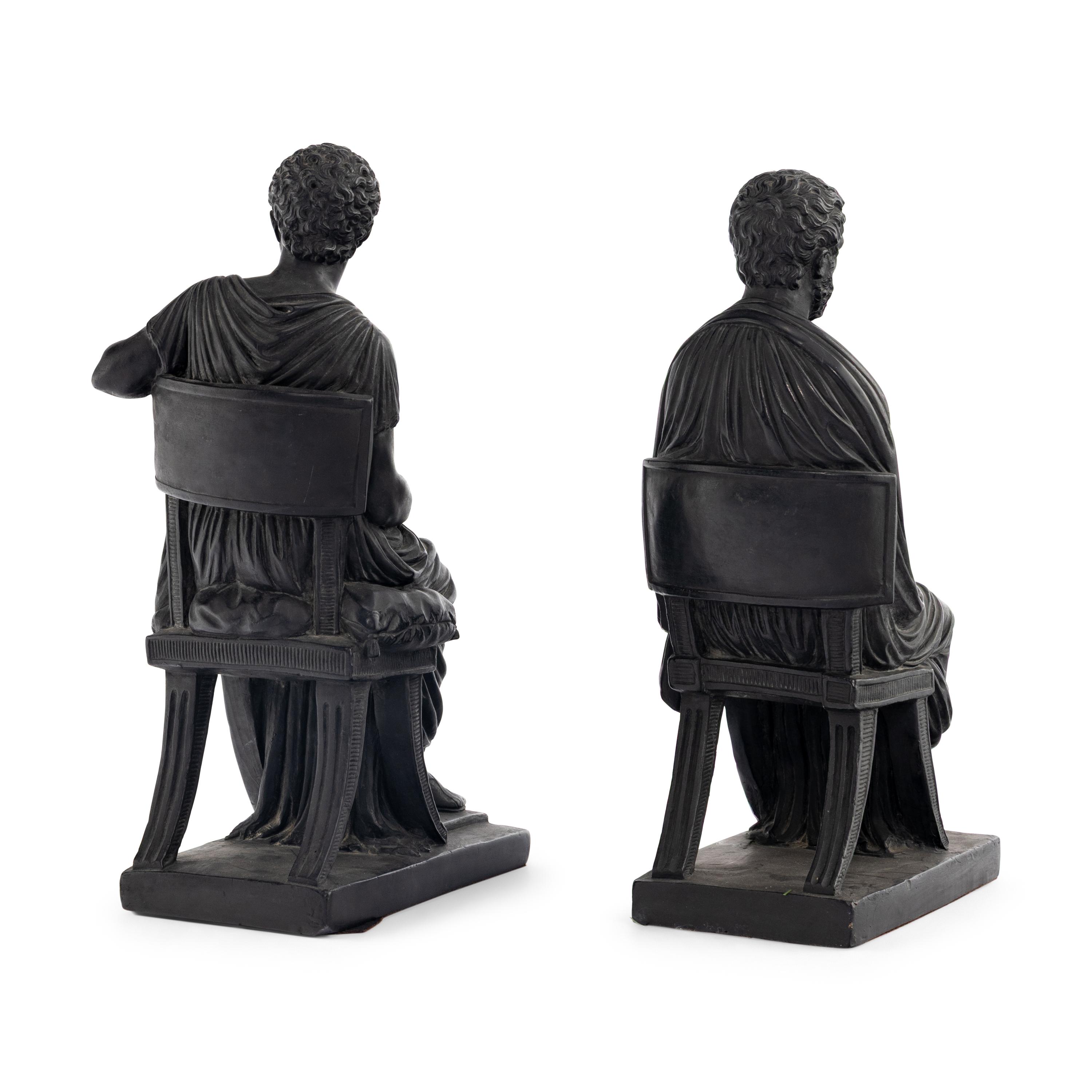A Pair of Black Earthenware or Composition Figures