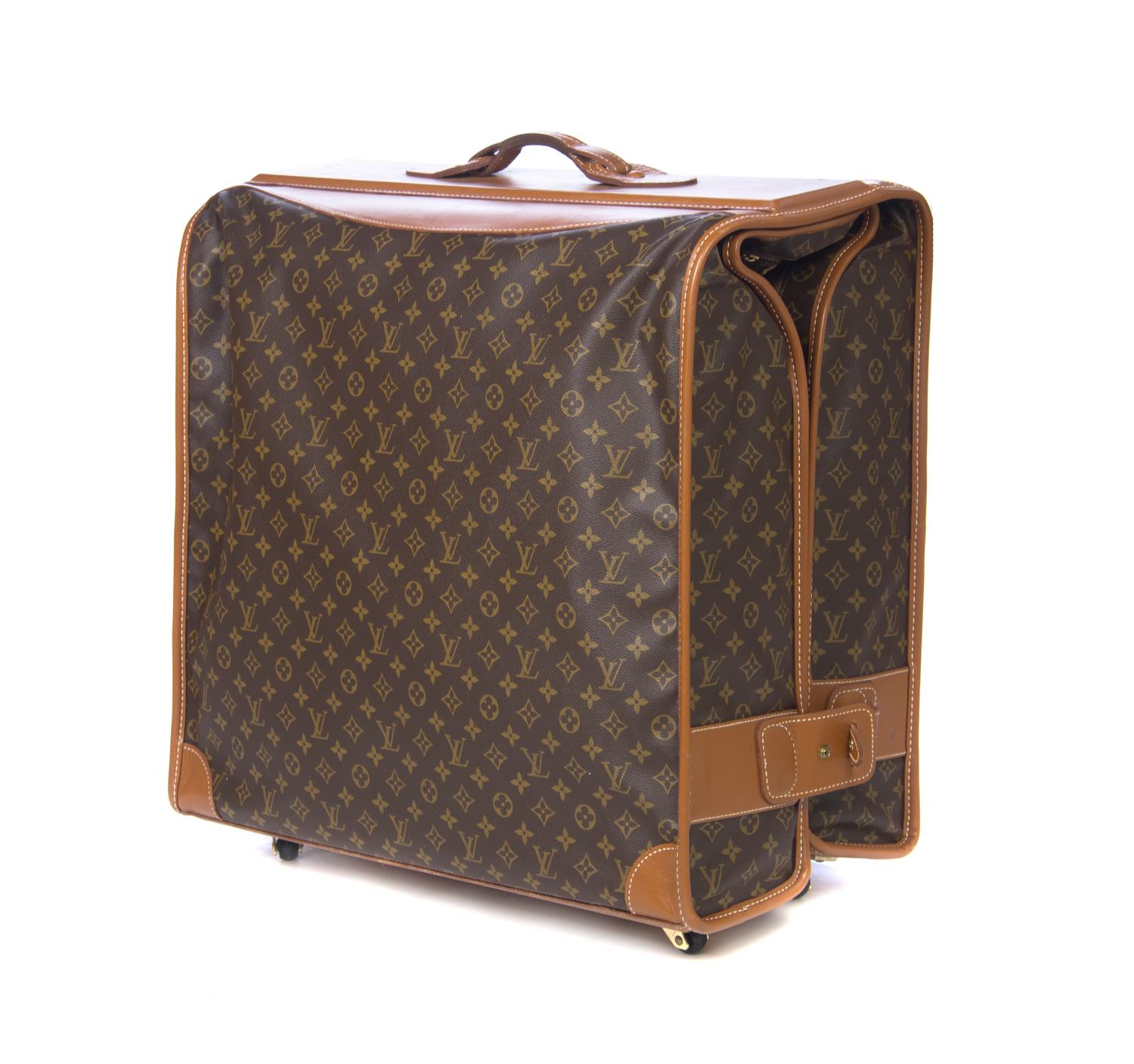 A Louis Vuitton Monogram Canvas Bi-Fold Garment Bag, 22 1/2 x 24 x 12 1/4 inches.