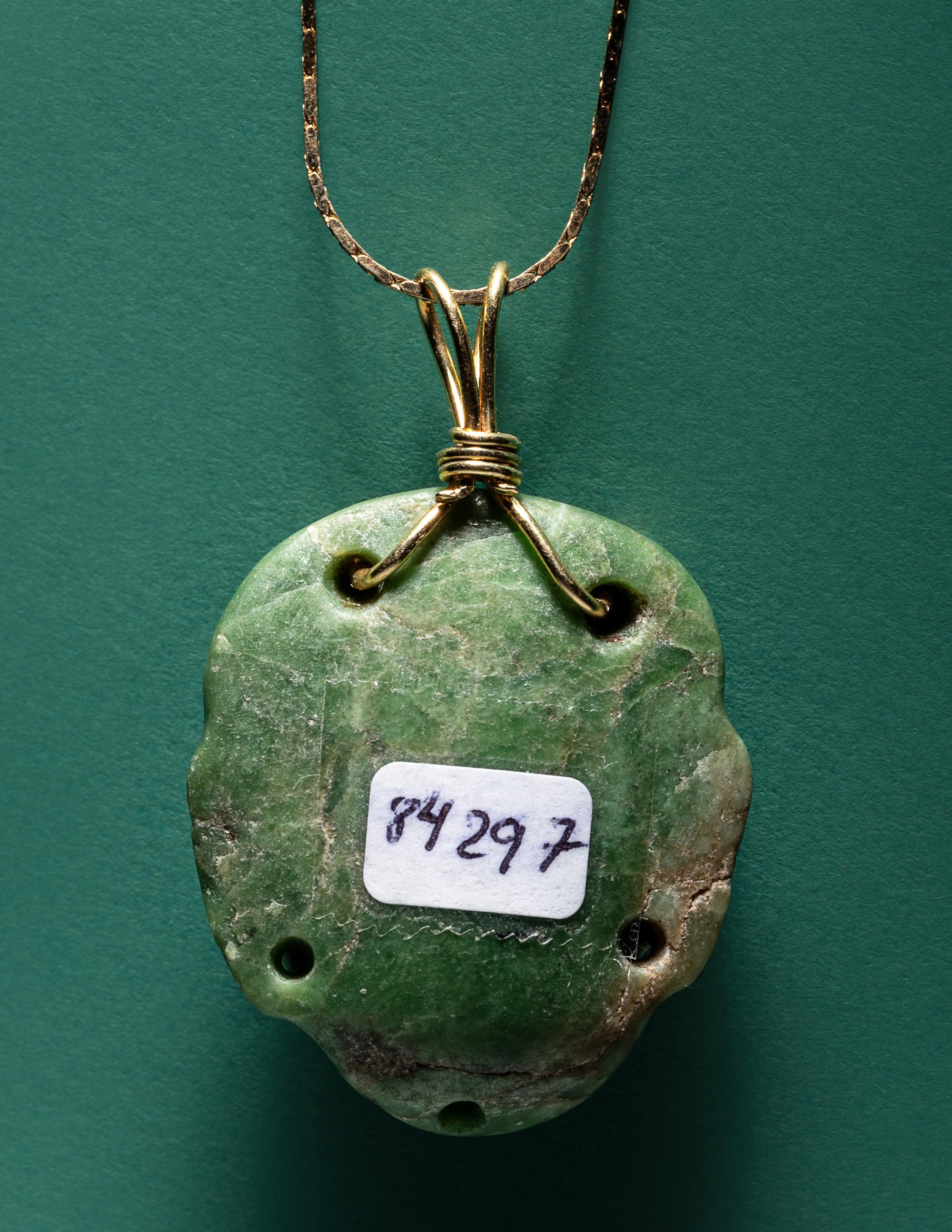 A Chontal Jade Maskette Pendant Necklace with Gold Chain
