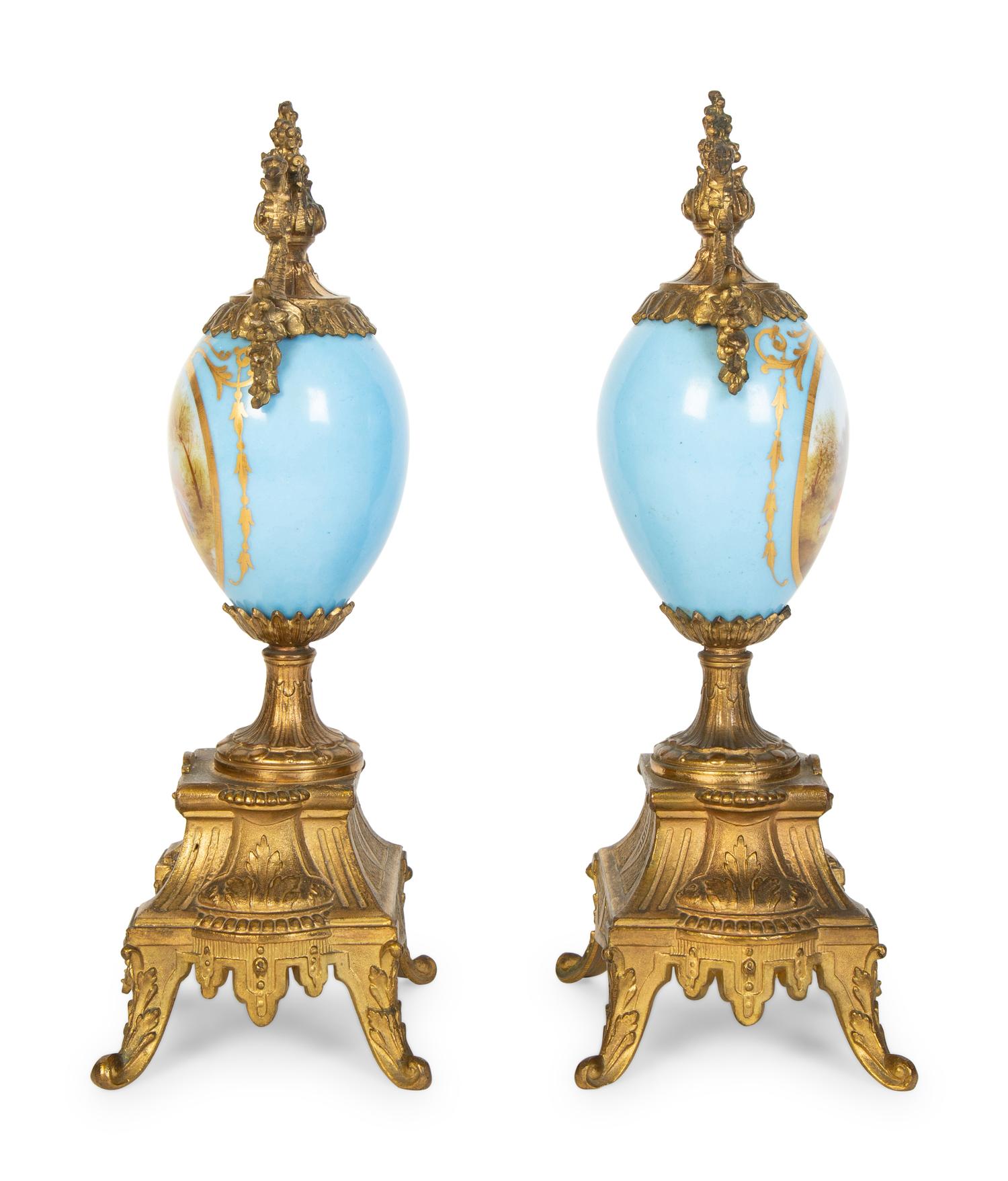A Pair of Sèvres Style Porcelain Small Urns with Gilt Metal Mounts