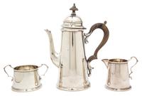 An American Silver Coffee Service, Redlich & Co., New York, NY, the coffee pot of lighthouse form with treen handle and finial, open su