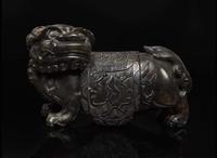 A Chinese carved mottled dark brown soapstone Buddhist lion, 18th century or earlier 壽山石獅子 十八世紀或更早