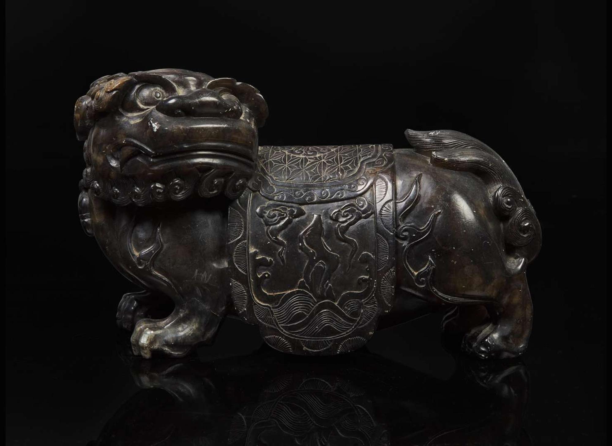 A Chinese carved mottled dark brown soapstone Buddhist lion, 18th century or earlier 壽山石獅子 十八世紀或更早