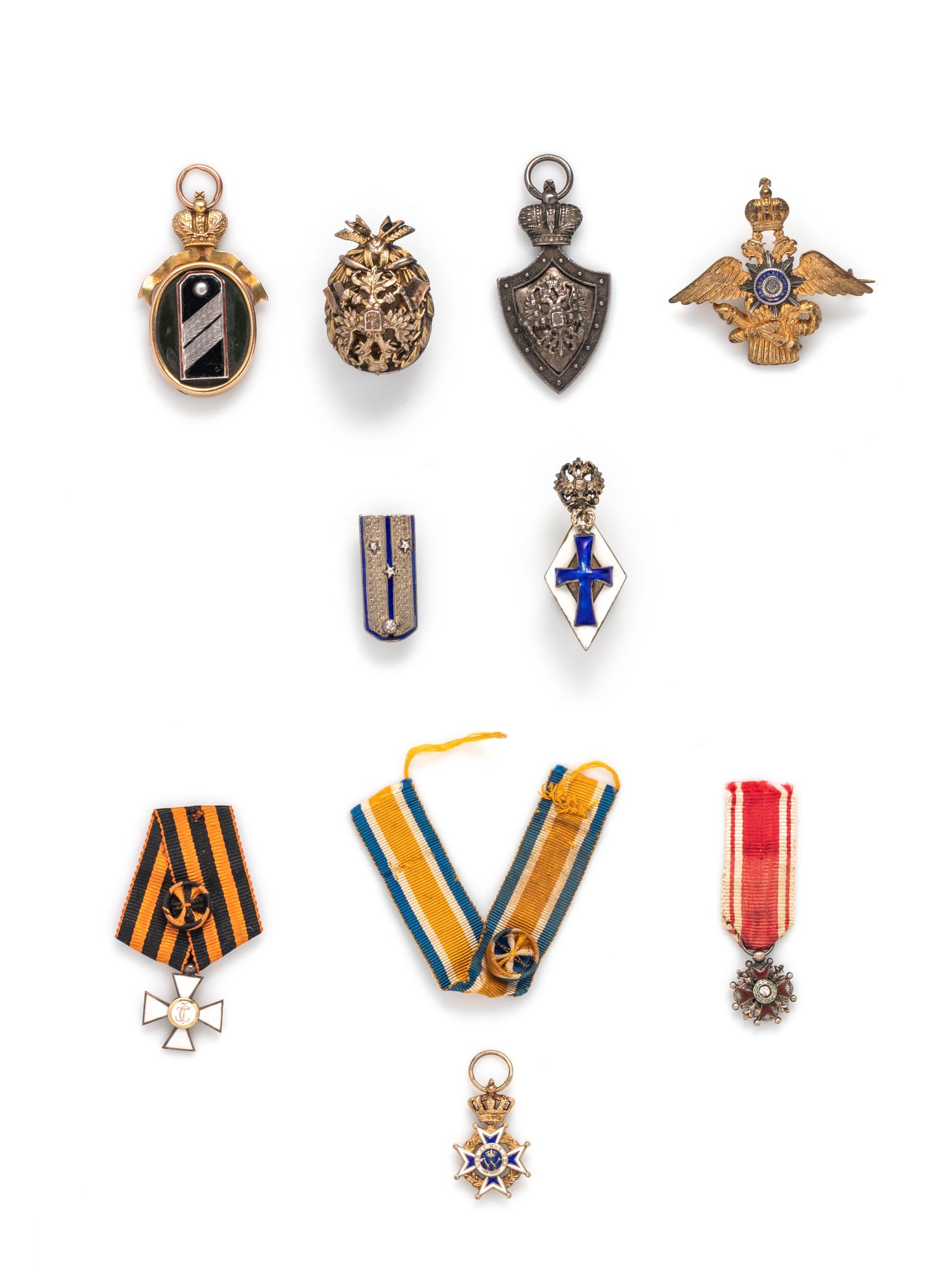A Group of Nine Silver, Gold and Enamel Orders of Merit and Badges