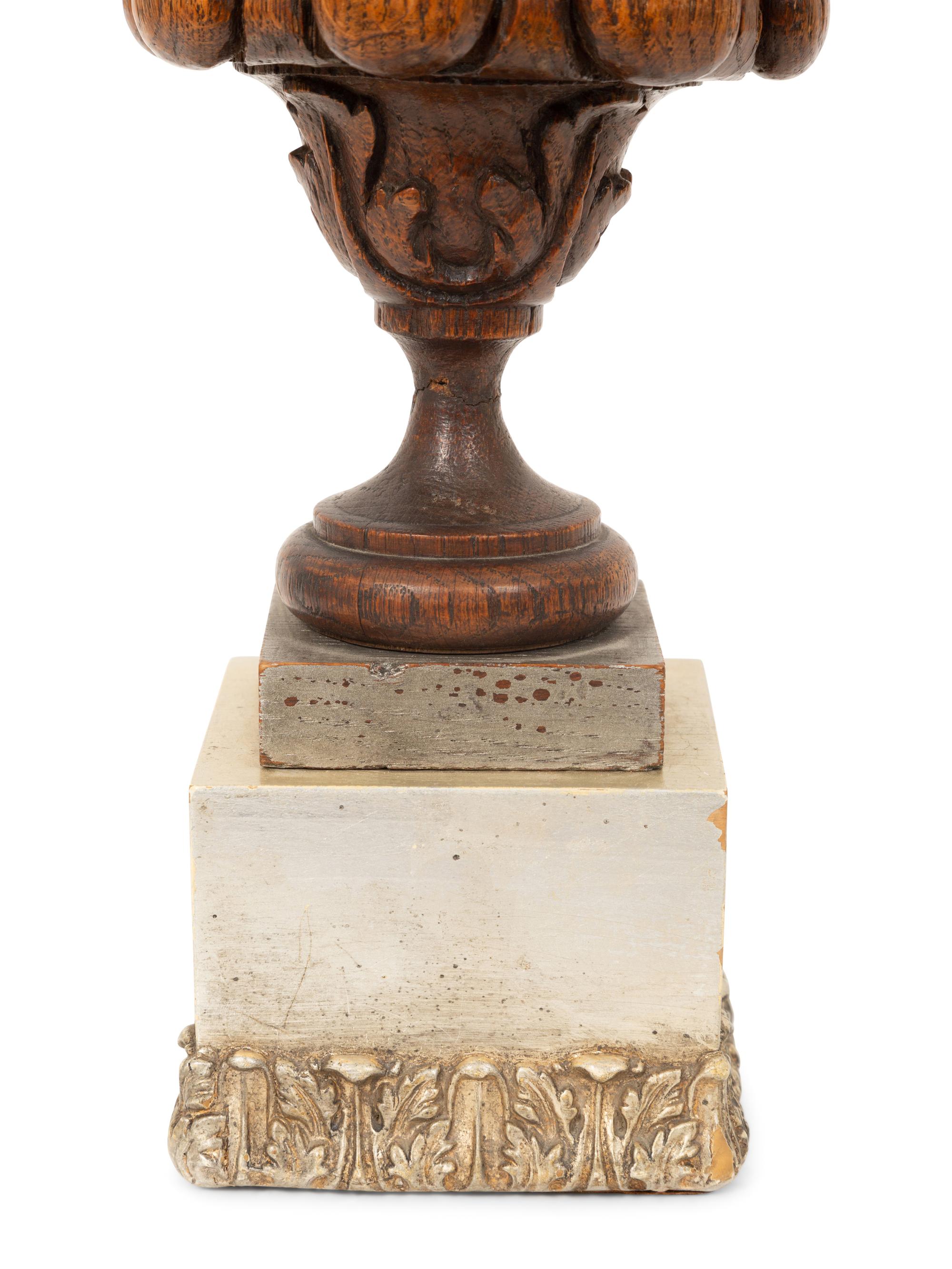 A Carved Oak Flaming Urn Finial Mounted on a Pedestal Base