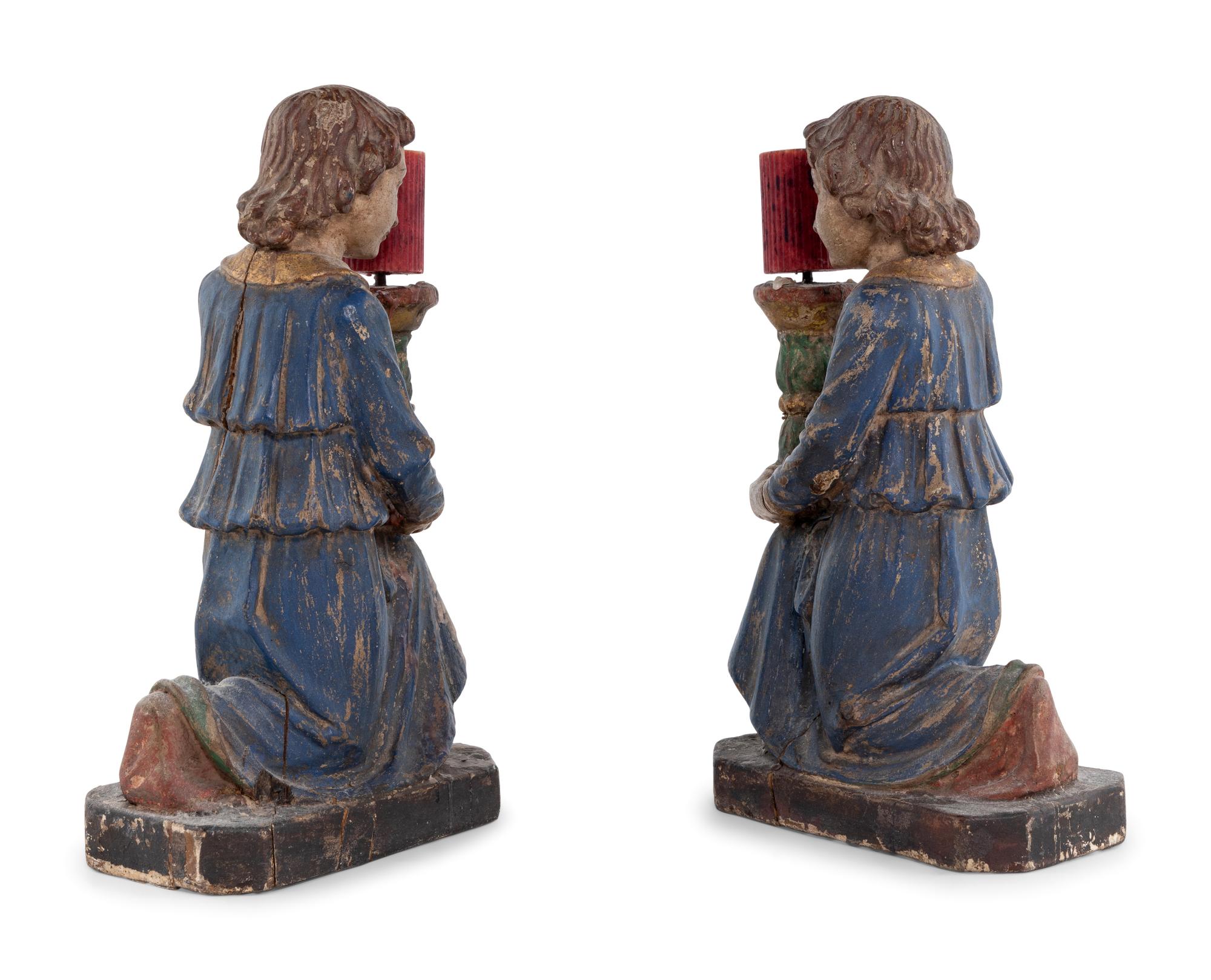 A Pair of Italian Carved and Polychrome Decorated Figural Candlesticks