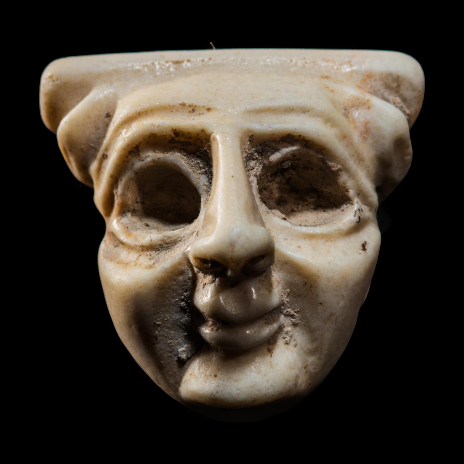 A Sumerian Limestone Face Amulet