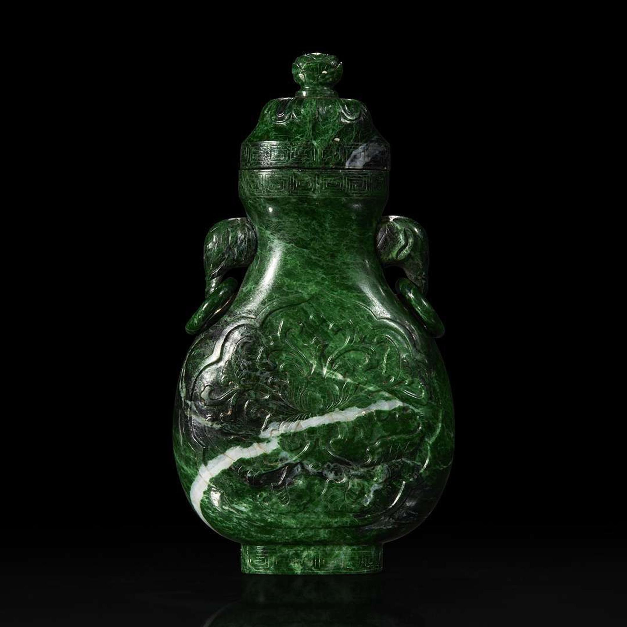 A Chinese carved chloromelanite vase and cover 玉盖罐