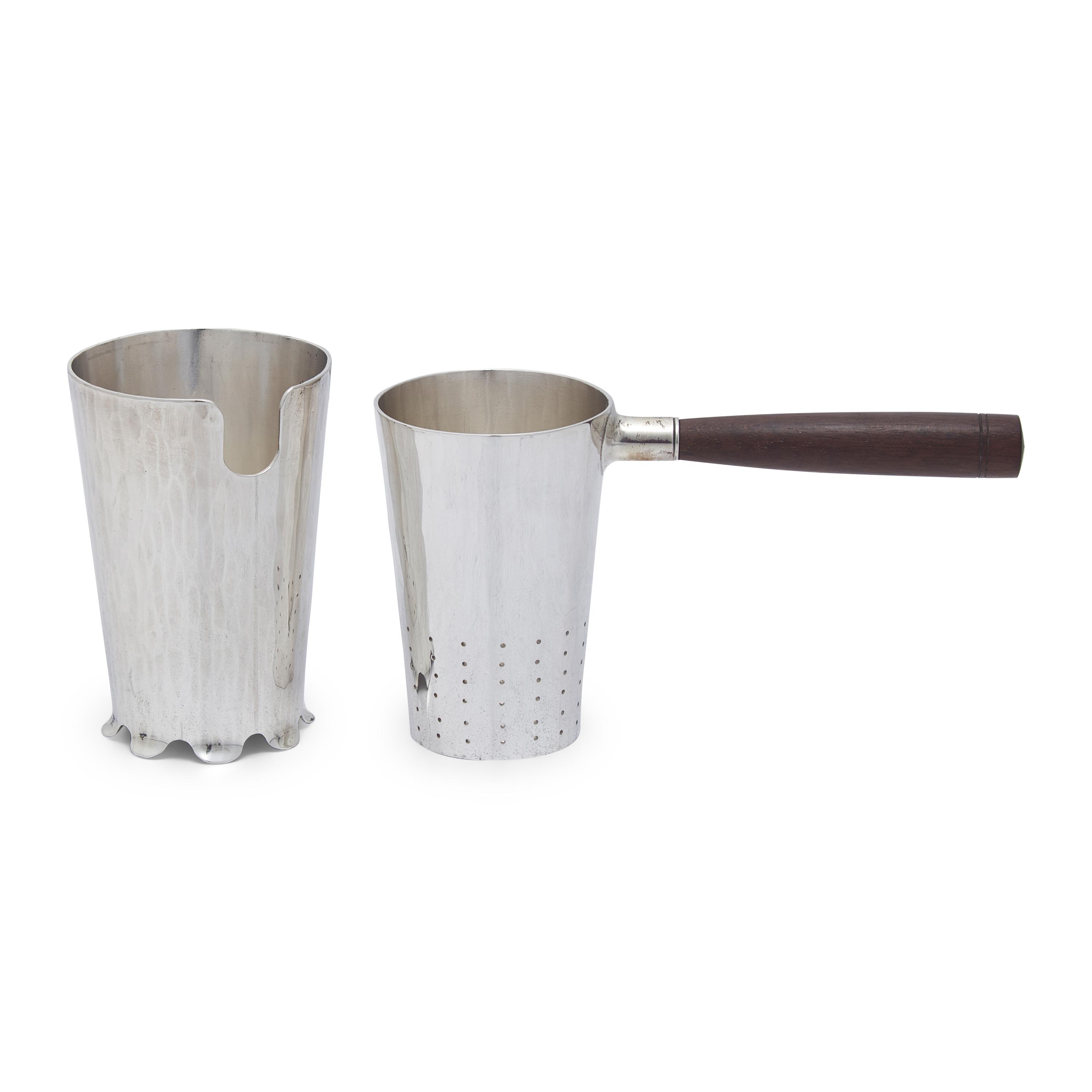 An Arts and Crafts Sterling Silver Tea Strainer and Stand