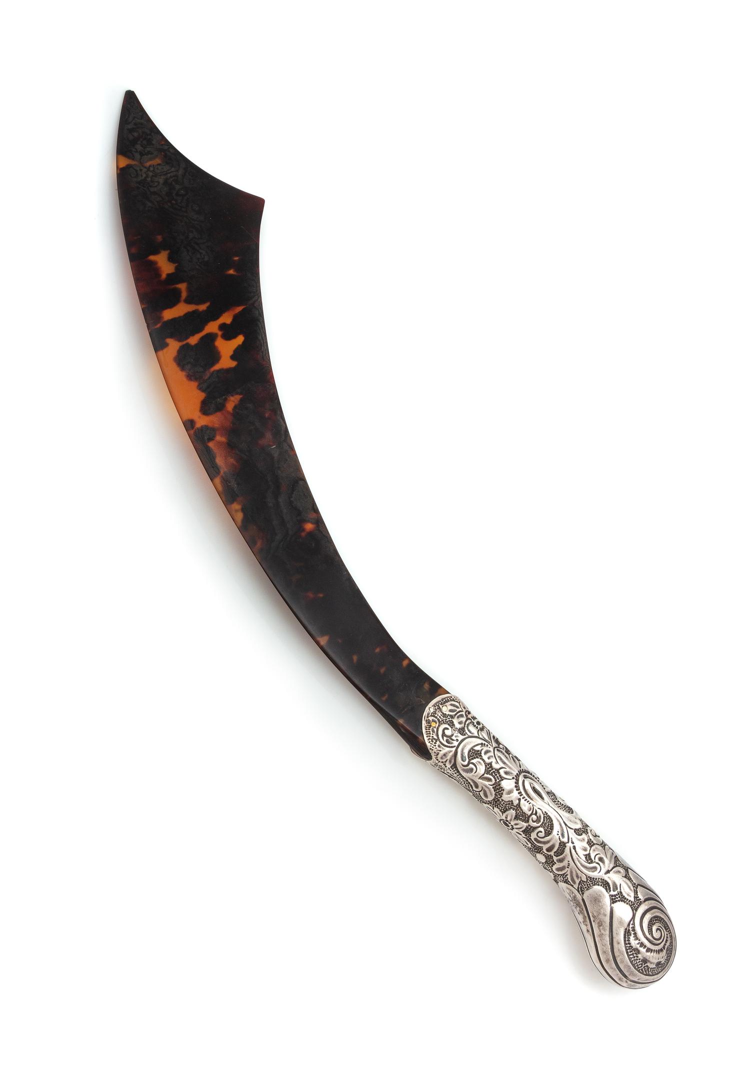 A Victorian Silver Mounted Tortoise Shell Page Turner, Maker's Mark Obscured, London, 1889, in the form of a scimitar.
