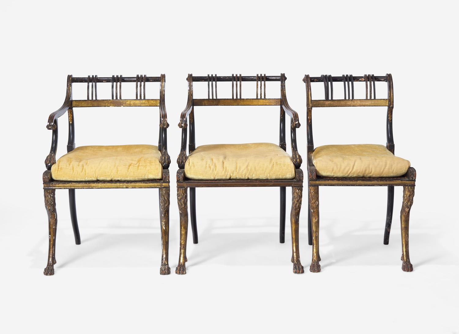 A Set of Three Regency Parcel-Gilt and Ebonized Caned Seat Dining Chairs