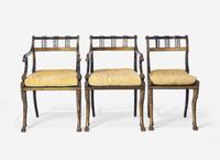 A Set of Three Regency Parcel-Gilt and Ebonized Caned Seat Dining Chairs