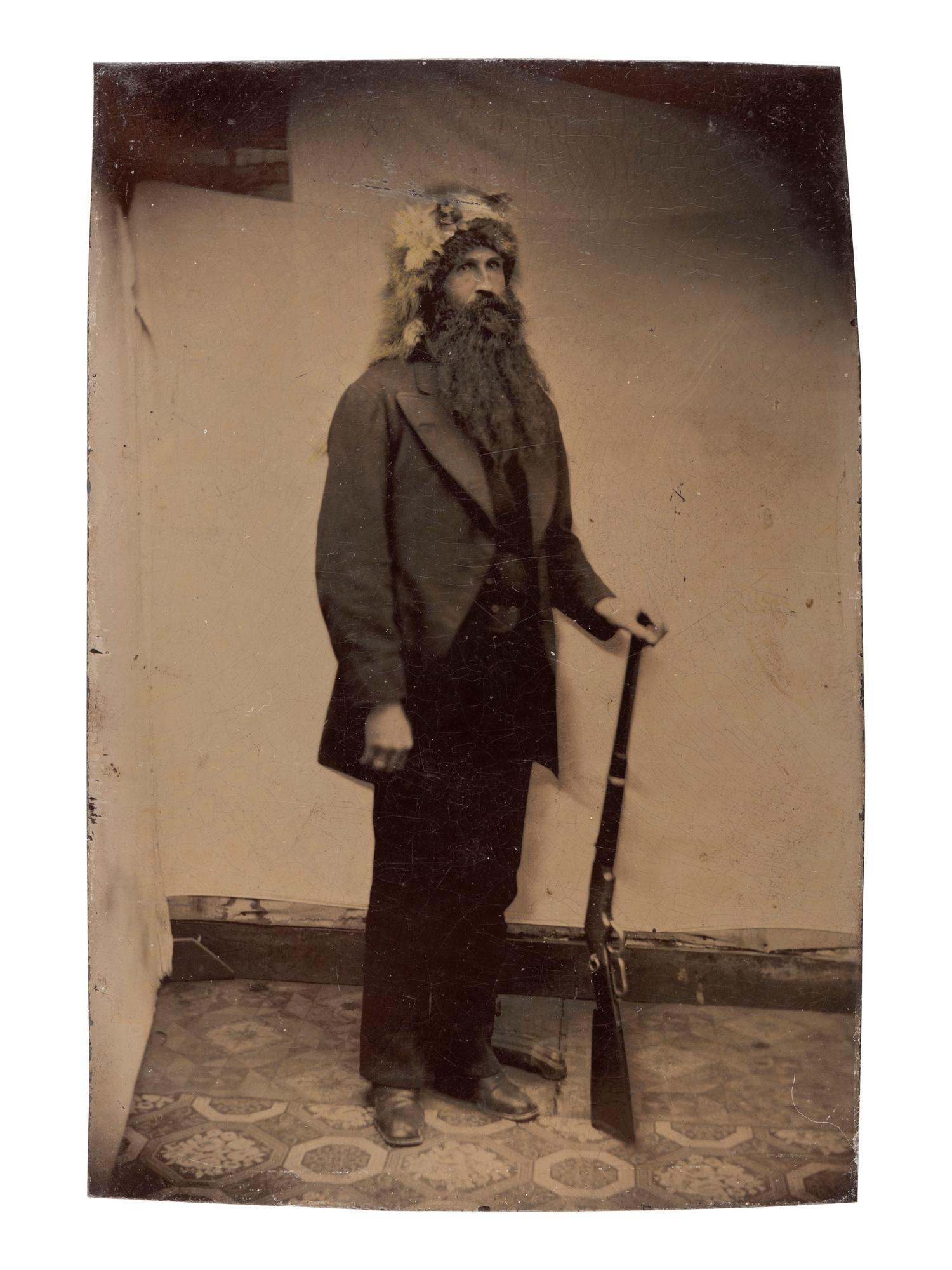 [WESTERN AMERICANA]. 3 tintypes of armed subjects, incl. frontiersman, soldier, and cowboys.