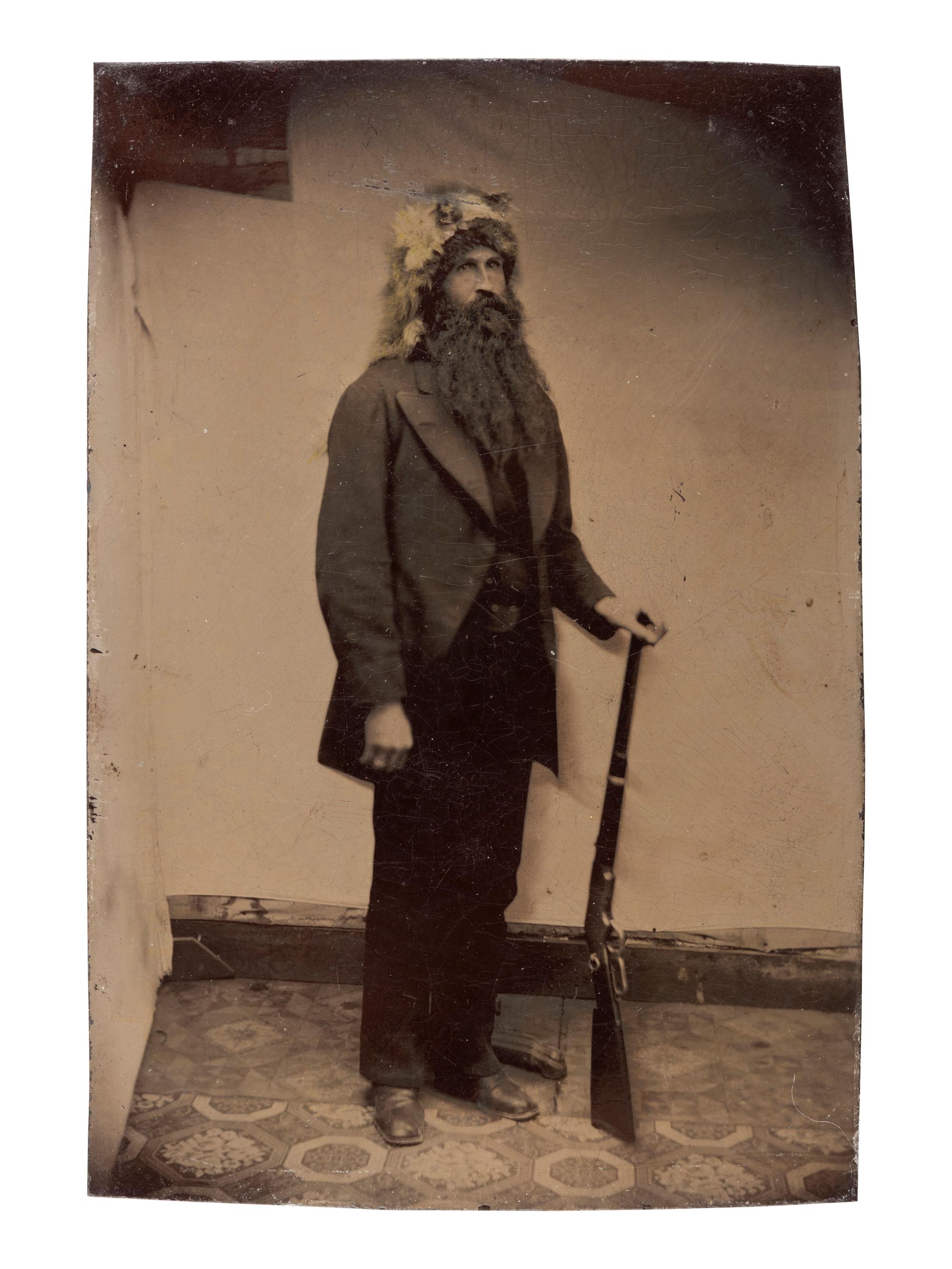 [WESTERN AMERICANA]. 3 tintypes of armed subjects, incl. frontiersman, soldier, and cowboys.