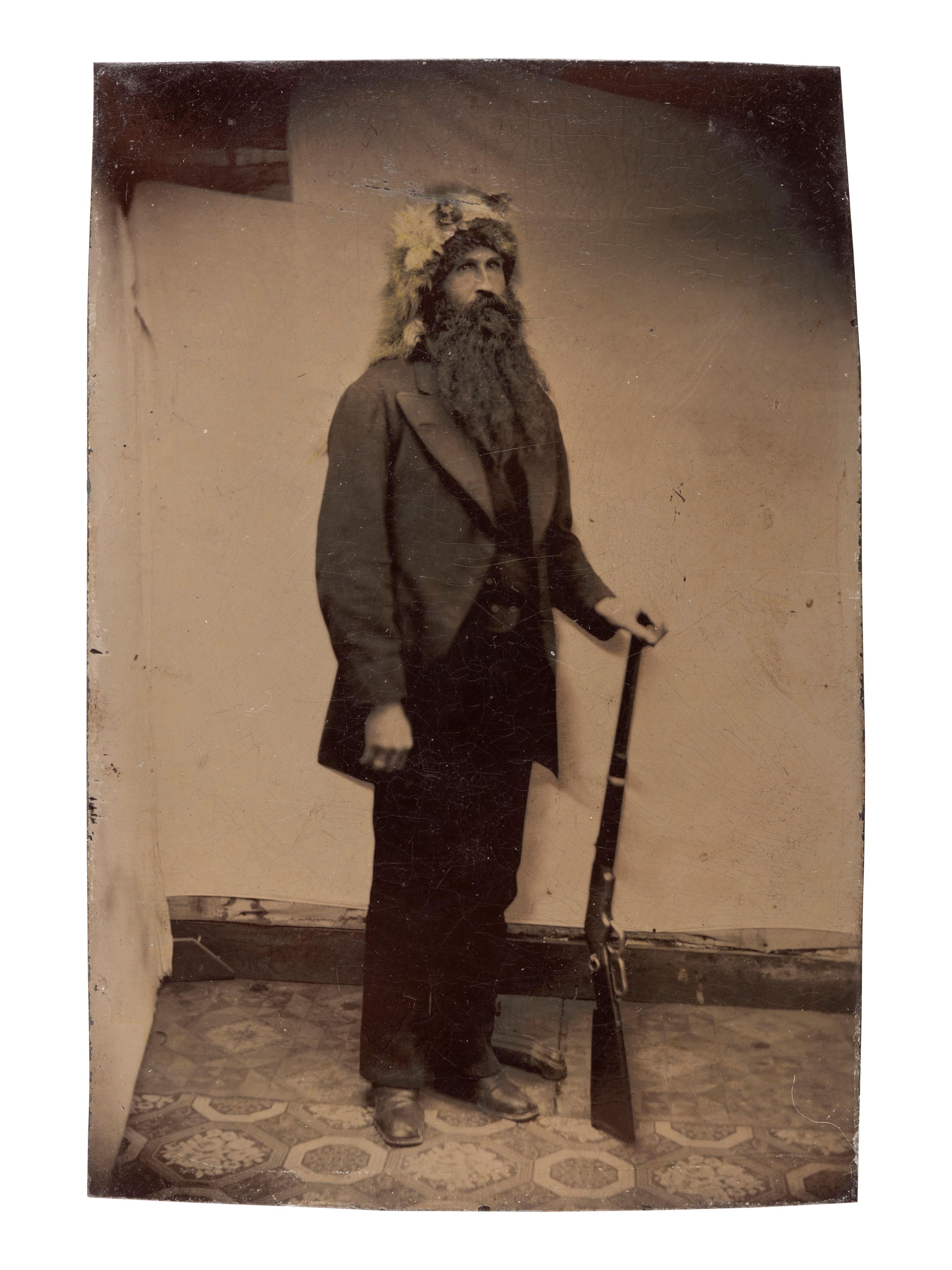 [WESTERN AMERICANA]. 3 tintypes of armed subjects, incl. frontiersman, soldier, and cowboys.