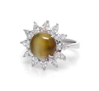 A Platinum, 18 Karat White Gold, Cat's Eye Chryosberyl and Diamond Ring, 5.90 dwts.