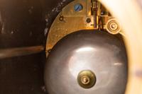 A French Patinated Bronze and Rouge Marble Figural Mantel Clock