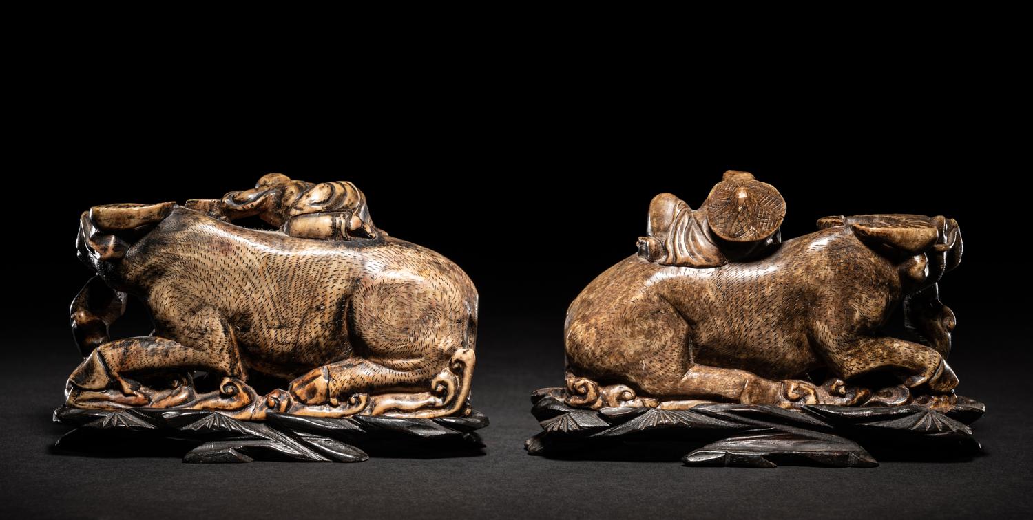 A Pair of Chinese Brown Hardstone 'Ox and Herd' Figural Groups