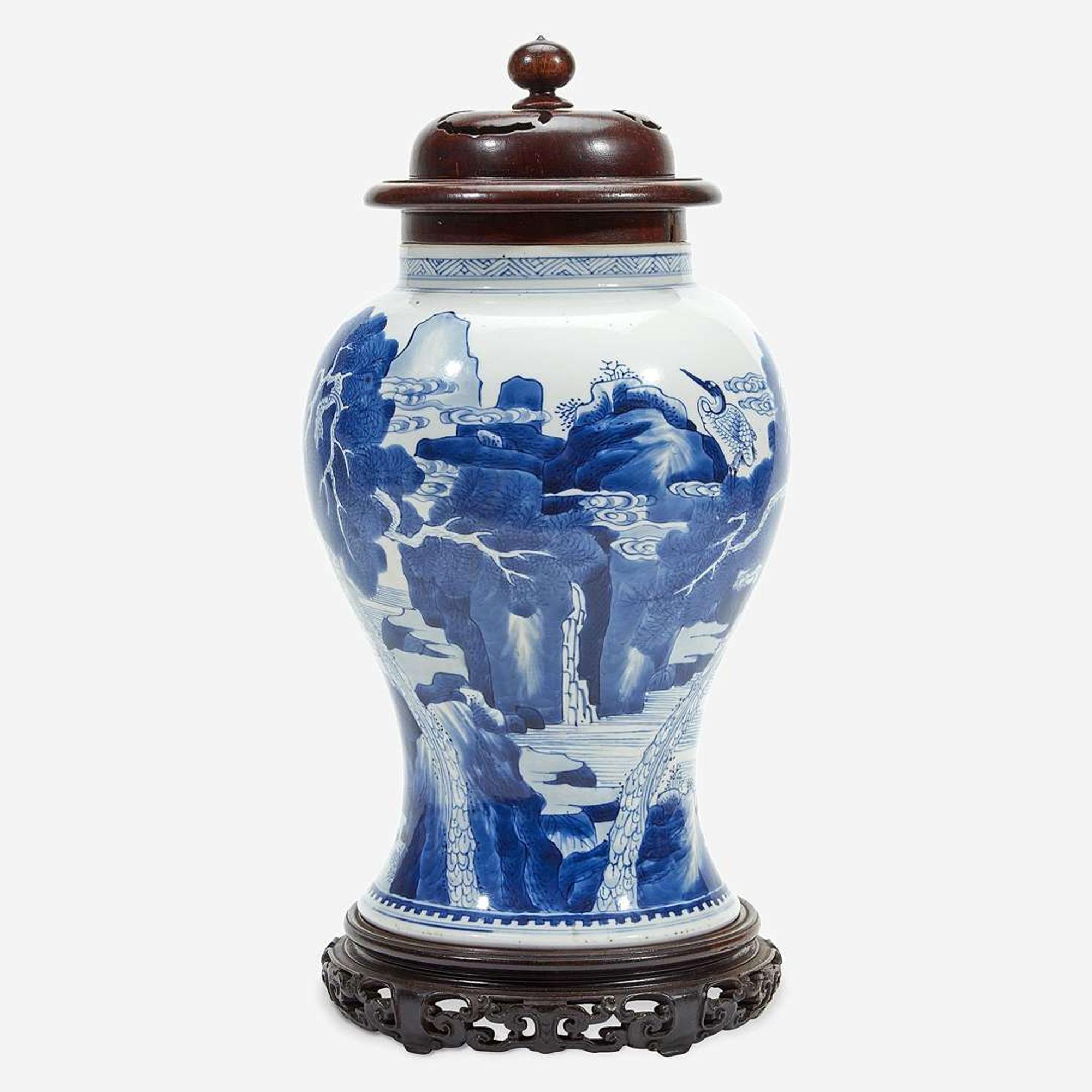 A Chinese blue and white porcelain vase with carved wood cover and stand The vase Kangxi period