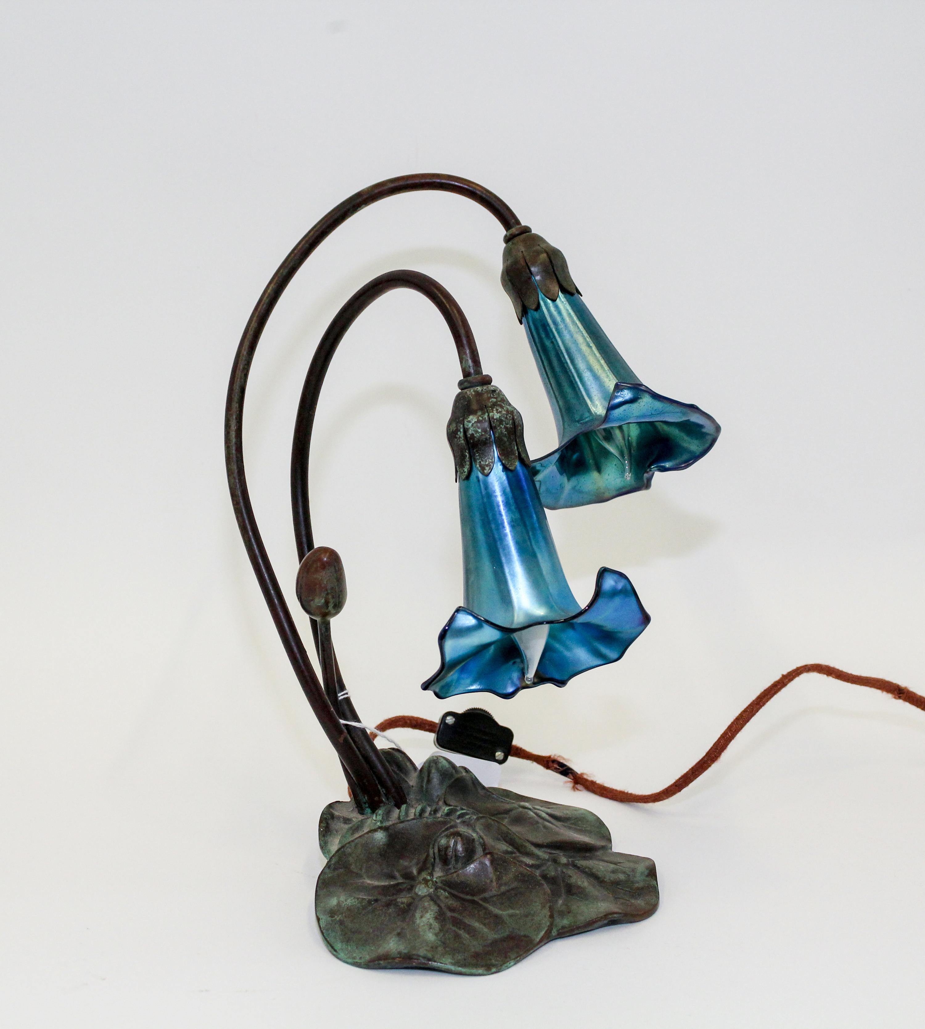 A Bronze and Glass Lamp Height 11 3/4 inches.