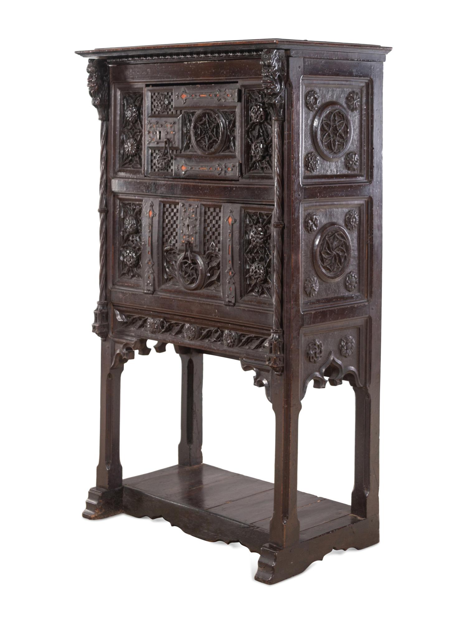 A Gothic Revival Carved Walnut Cabinet on Stand