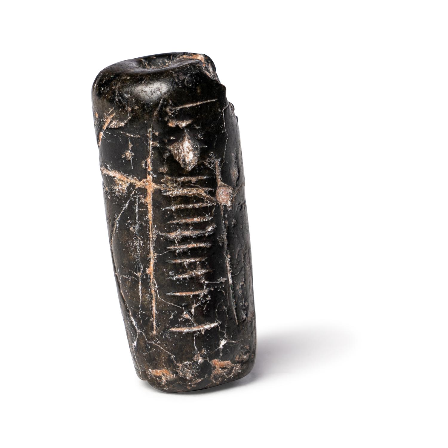 A Mesopotamian Black Steatite Cylinder Seal