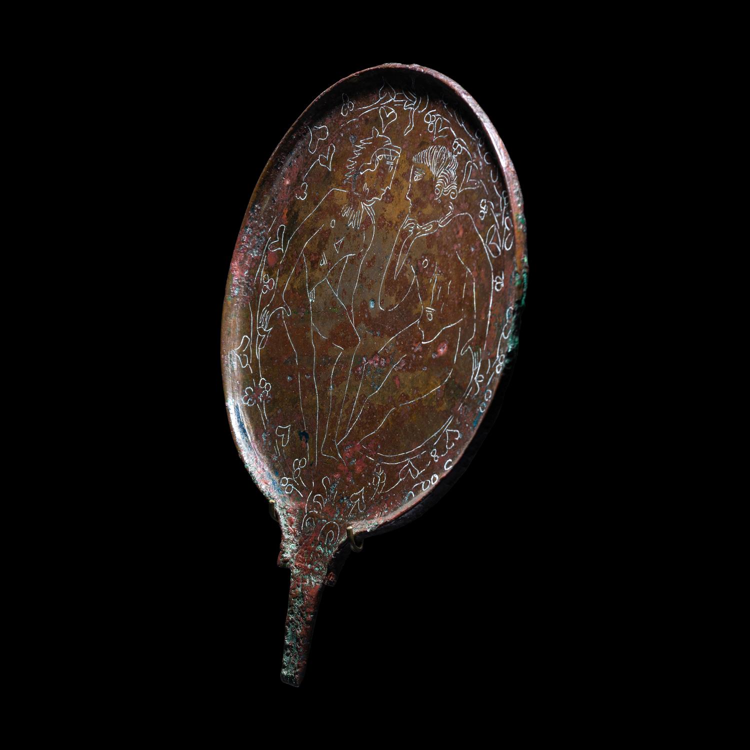 An Etruscan Bronze Mirror with Incised Scene of Hercules and Apollo