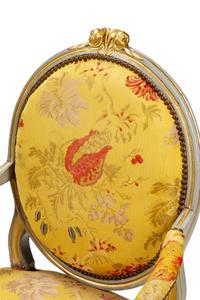 A Pair of Louis XVI Painted and Parcel Gilt Fauteuils