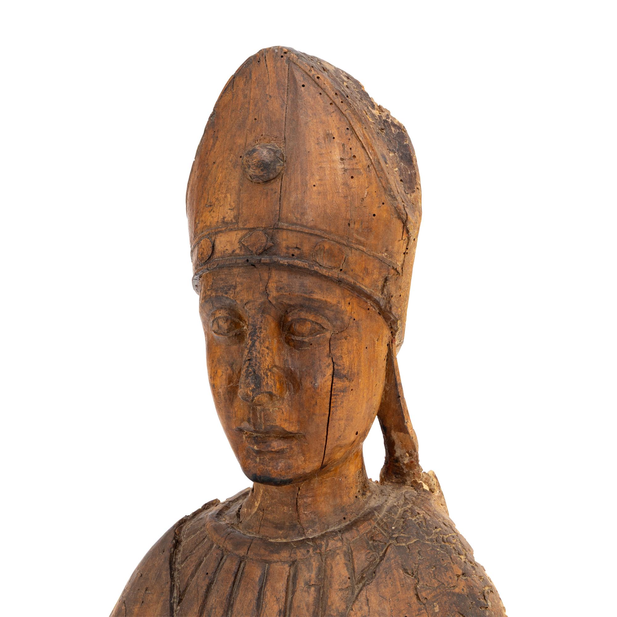 A Carved Walnut Figure of a Bishop