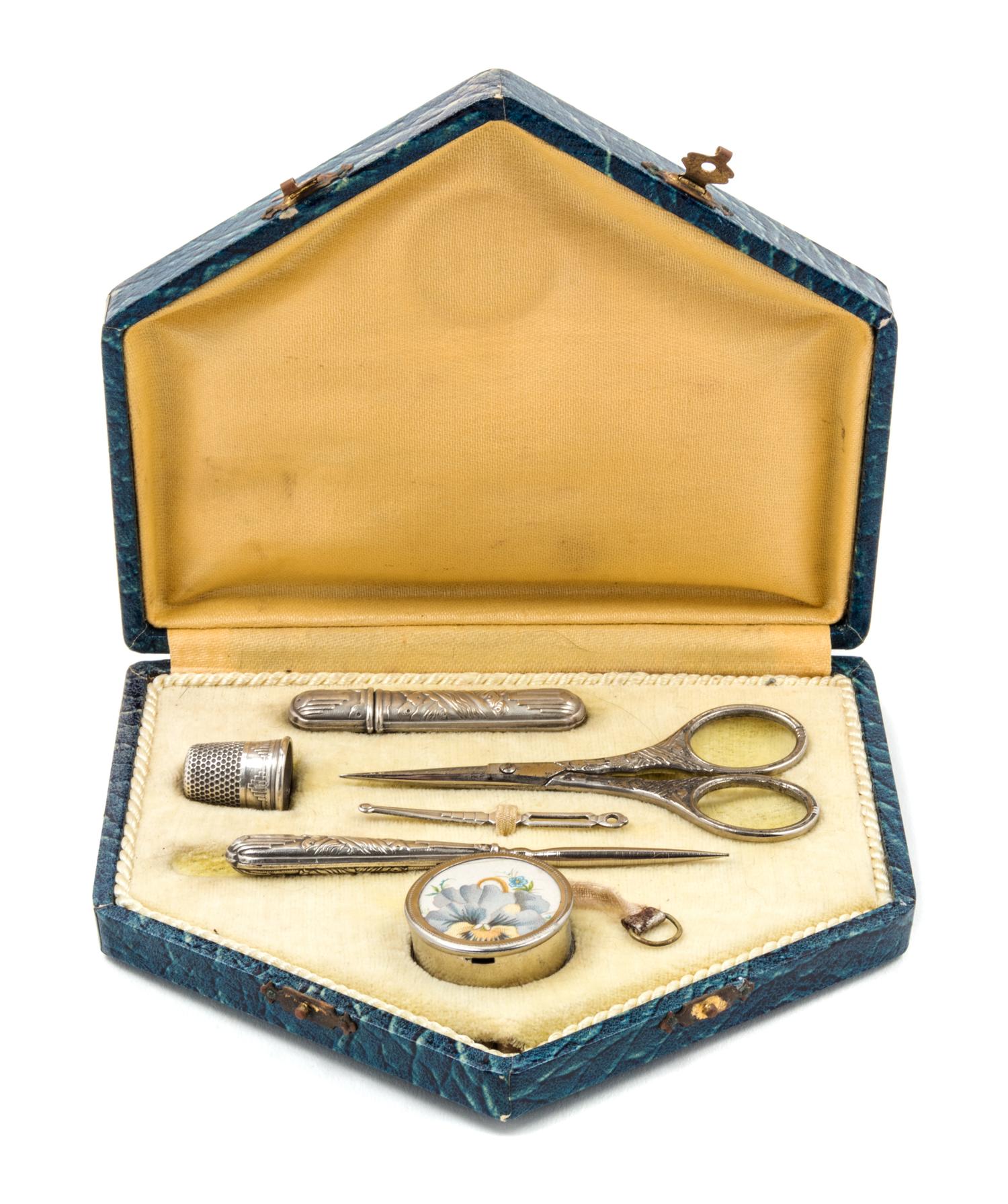 An Art Deco Silvered Metal Sewing Kit, , fitted with a needle case, bodkin, thimble, scissors, stiletto and tape measure.