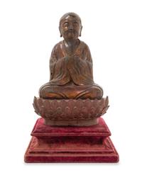 A Chinese Gilt Lacquered Bronze Figure of a Monk MING DYNASTY Height 12 x width 8 inches. — MING DYNASTY