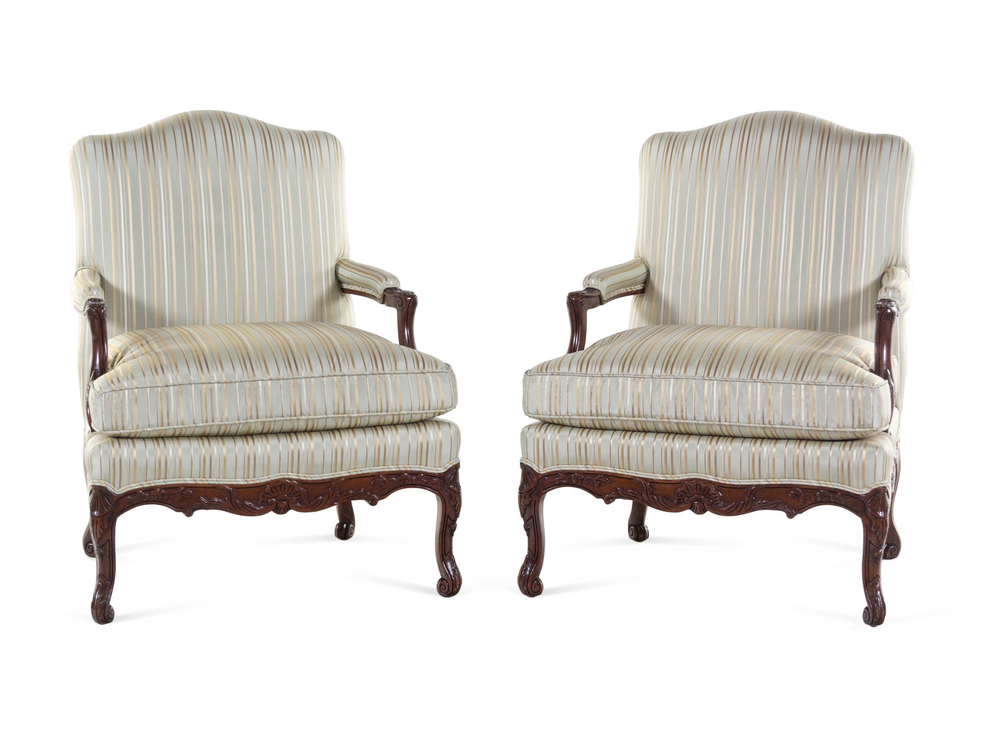 A Pair of Louis XV Style Carved Walnut Fauteuils