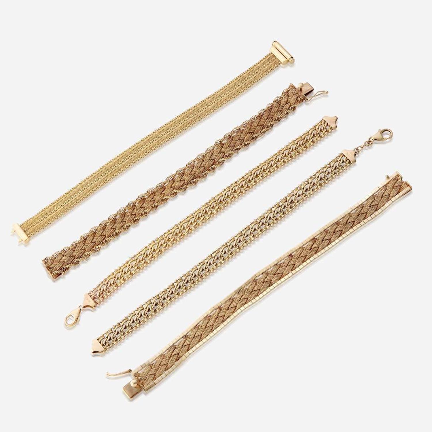 A collection of five fourteen karat gold bracelets
