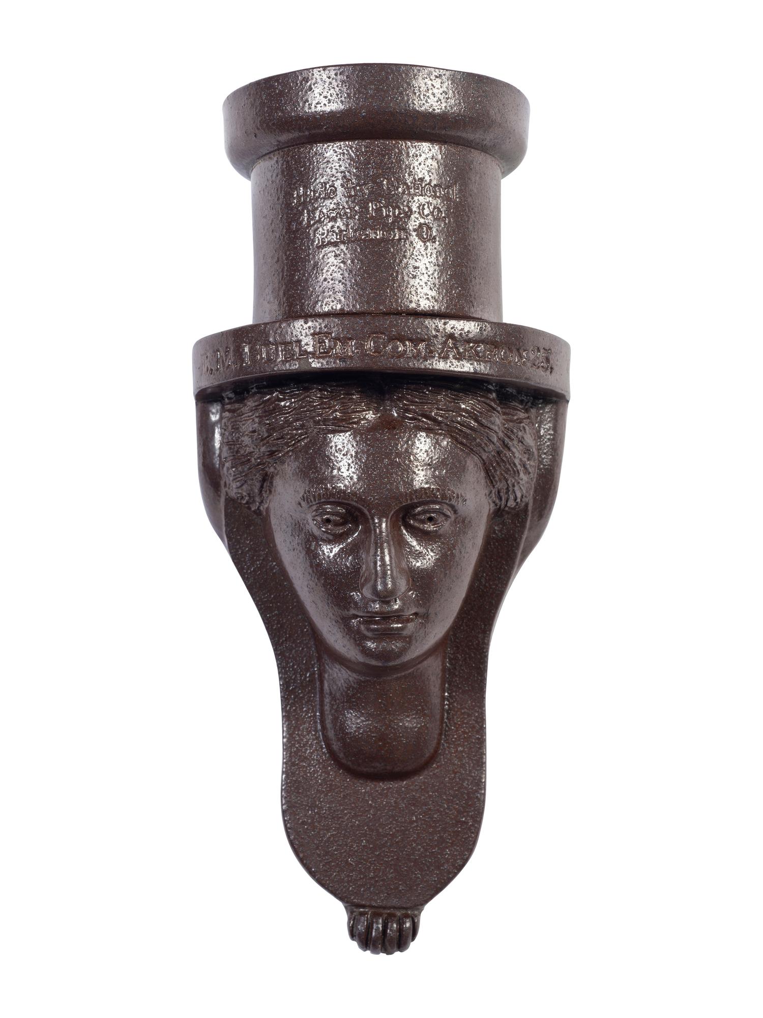A Glazed Sewer Tile 'Liberty Head' Hanging Match Holder