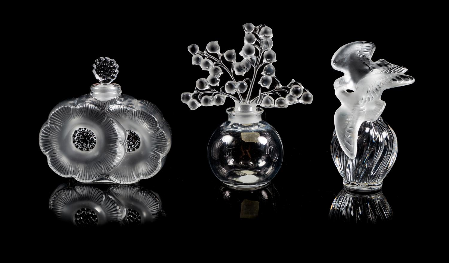 Lalique, a group of three molded and frosted glass Clairefontaine, Deux Fleurs and L'Air du Temps Fatice perfume bottles