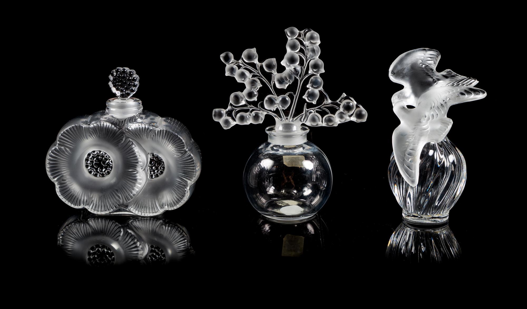 Lalique, a group of three molded and frosted glass Clairefontaine, Deux Fleurs and L'Air du Temps Fatice perfume bottles
