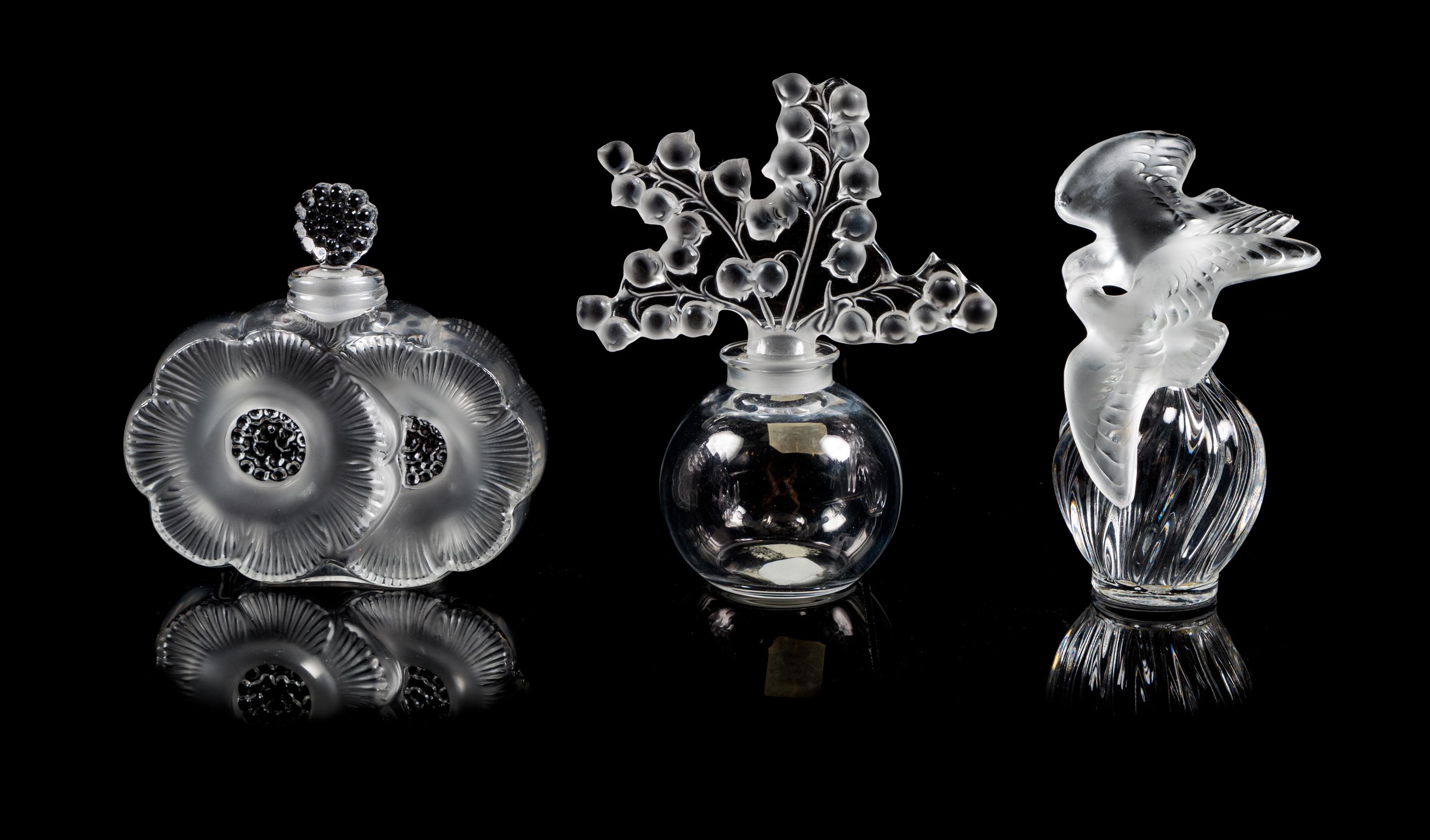 Lalique, a group of three molded and frosted glass Clairefontaine, Deux Fleurs and L'Air du Temps Fatice perfume bottles