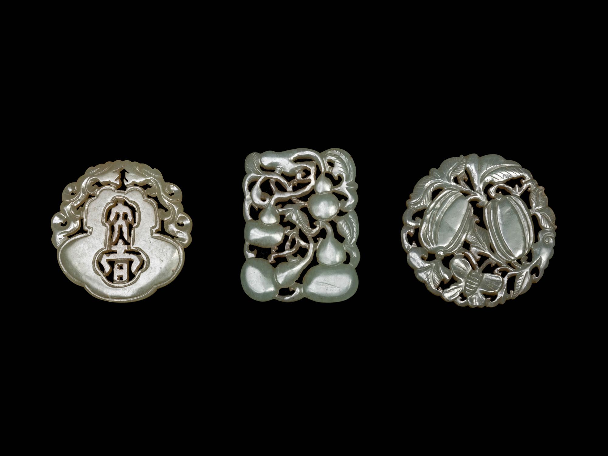 Three Chinese Pale Celadon Jade Reticulated Pendants