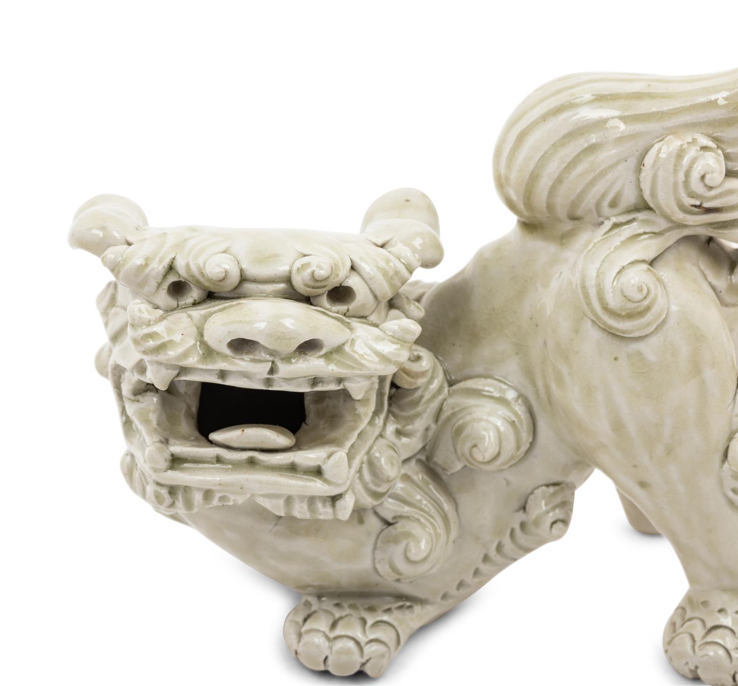 A Pair of Chinese White Glazed Porcelain Figures of Fu Lions