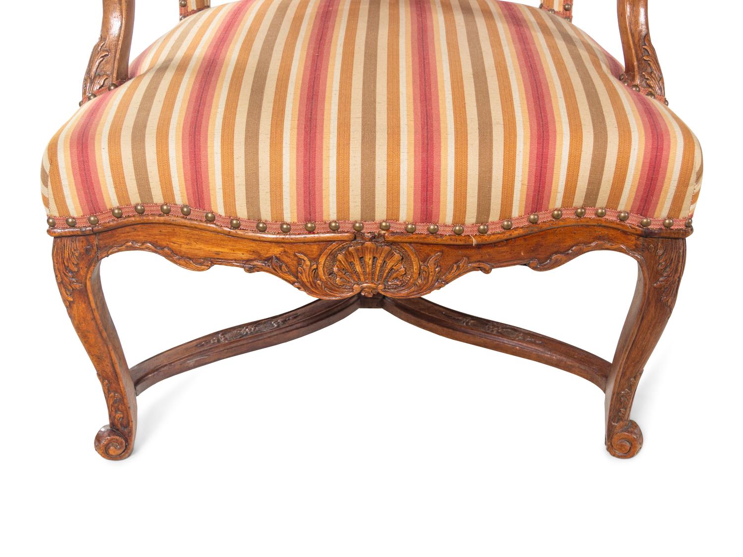 A Pair of Régence Carved Walnut Armchairs