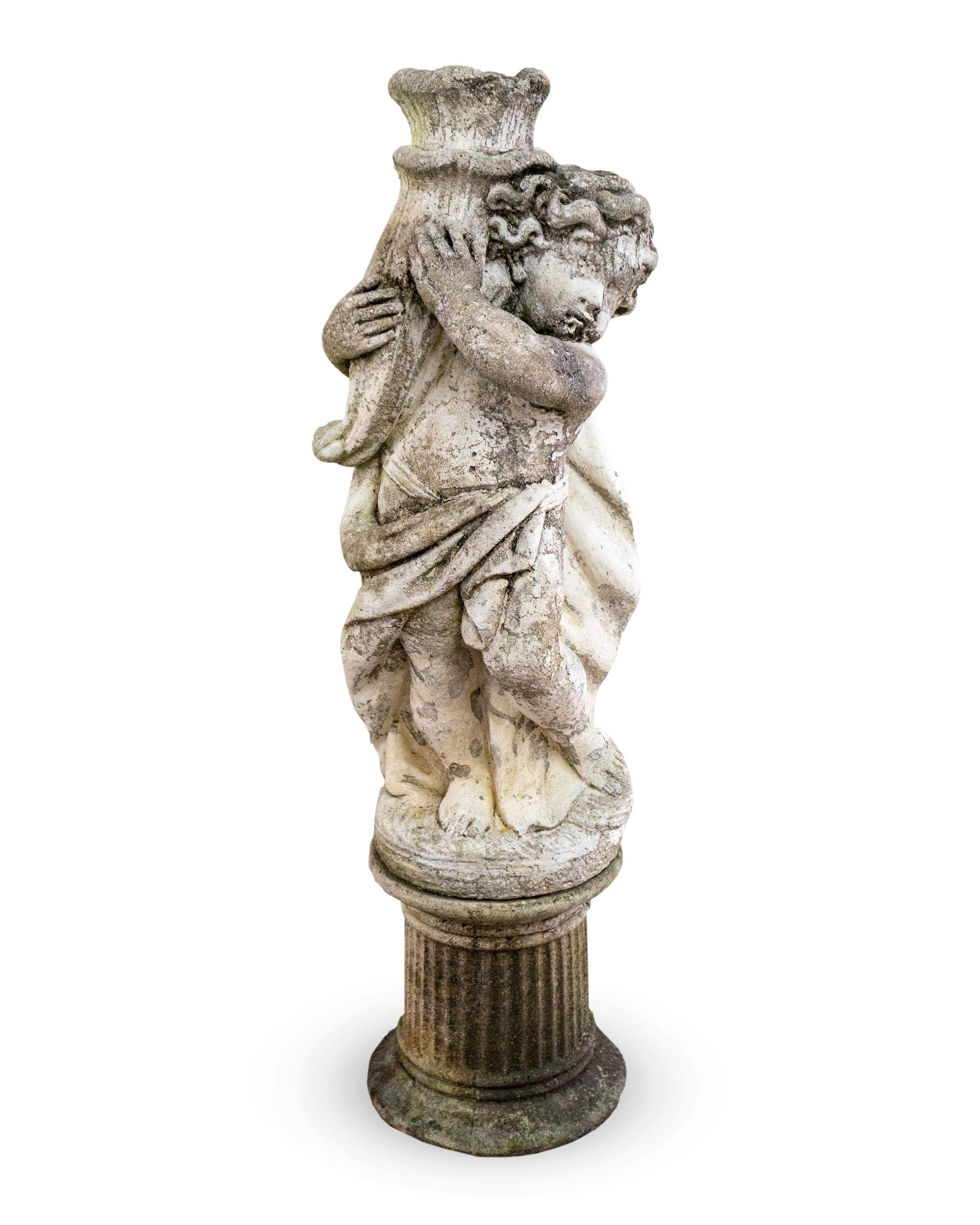 A Cast Stone Figure of a Putto Holding a Cornucopia — 20TH CENTURY