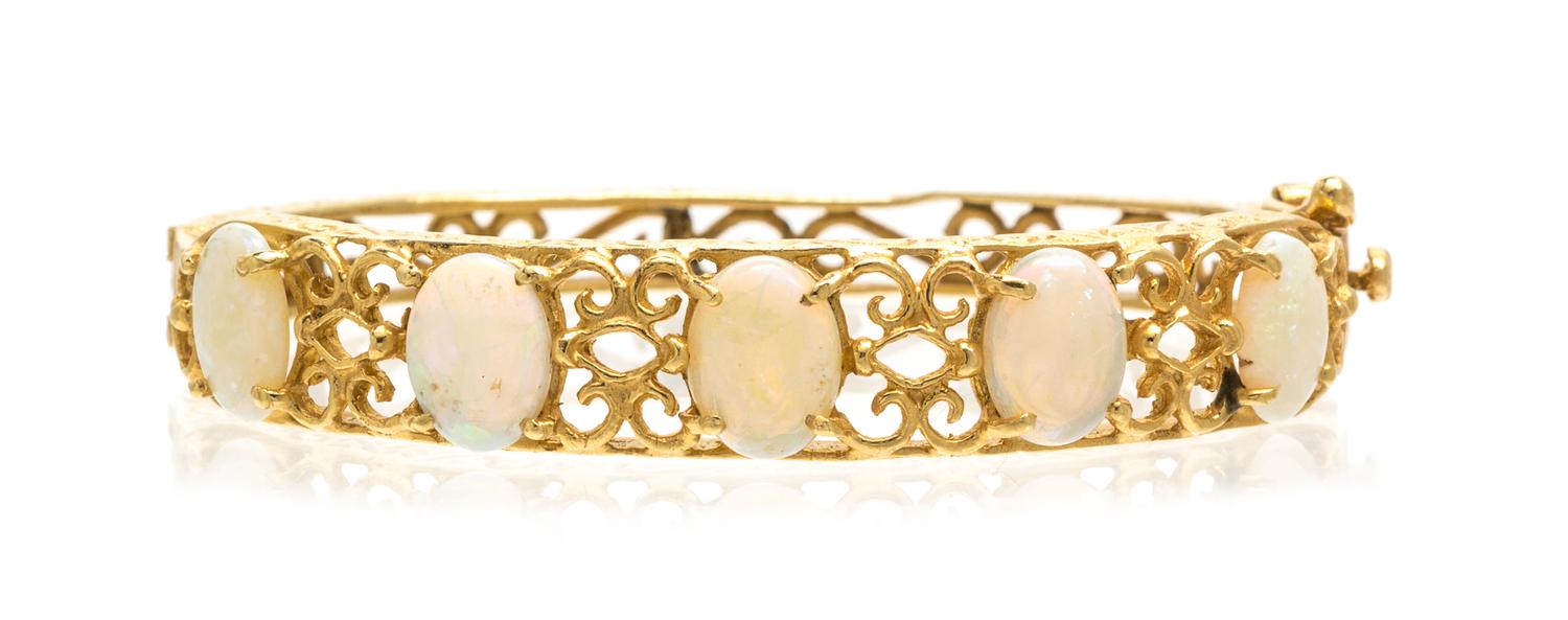 A 14 Karat Yellow Gold and Opal Bangle Bracelet, 9.30 dwts.