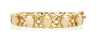 A 14 Karat Yellow Gold and Opal Bangle Bracelet, 9.30 dwts.