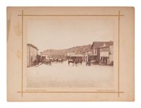 KNIGHT, George H., photographer. Street scene in Bradley, California, including photographer’s wagon. San Francisco, CA: 1886.