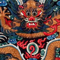A Chinese Navy Satin Ground Embroidered Silk 'Dragon and Crane' Robe, Qiagua , Late 19th Century 清晚期 石青緞地綉龍紋團鶴紋袷褂