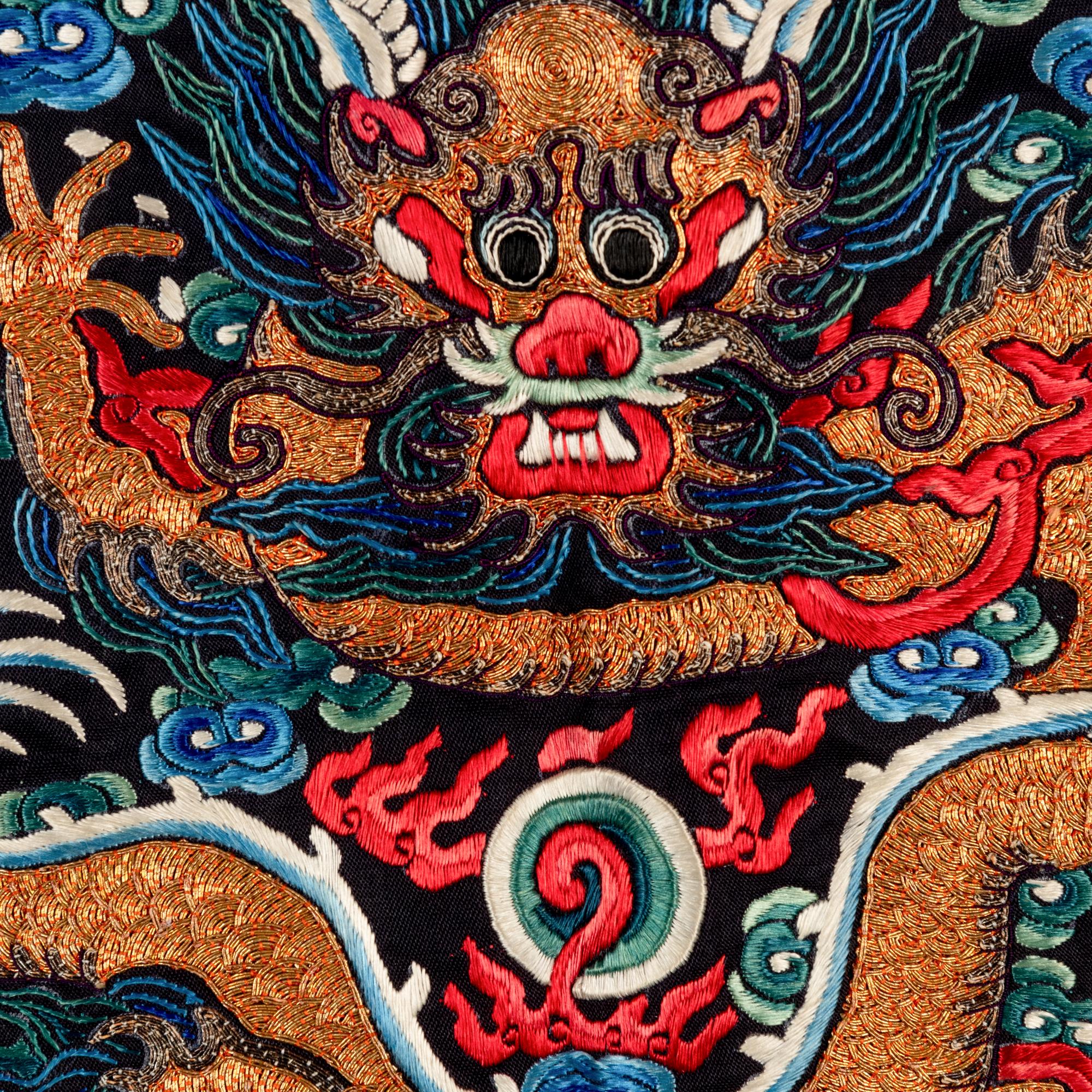 A Chinese Navy Satin Ground Embroidered Silk 'Dragon and Crane' Robe, Qiagua , Late 19th Century 清晚期 石青緞地綉龍紋團鶴紋袷褂